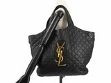 a close up of a black purse on a mannequin stand
