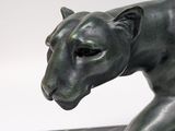 statue of a black panther on a marble base on a white background