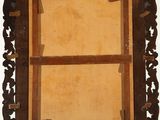 an old wooden frame with a picture hanging on it ' s side