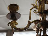 a gold colored chandelier hanging from the ceiling