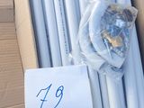 a pile of white pipes sitting on a cardboard box