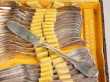 a lot of forks and spoons in a box