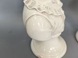 a white statue of a girl with a flower in her hair