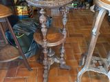 a table and two stools in a room