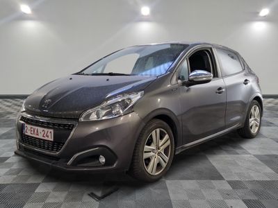 the grey car is parked on a checkered floor in the garage