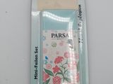 a close up of a package of perfume on a white surface