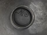 a close up of a black vase with writing on it