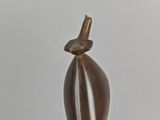 a bronze sculpture of a bird on top of a person ' s head