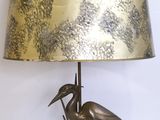 a lamp that is on a table with a bird on it