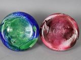 two glass marbles sitting next to each other on a table