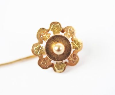 an image of a gold ring with a pearl in the center