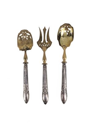 three silver spoons and a spoon with a flower on them