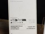 a white box on a wooden table with a laptop on it