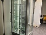 an image of a refrigerator with a glass door in a room