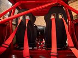 two red seats in the back of a red car