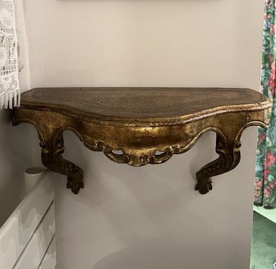 a picture of a wooden shelf with a mirror above it
