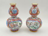 pair of chinese vases with asian scenes on them on a white background