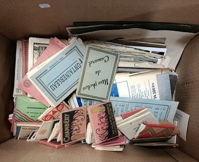 a cardboard box full of books and papers in it