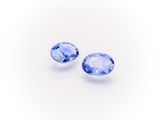 a pair of tanzanite gems on a white background