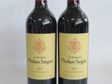 two bottles of wine sitting next to each other on a table