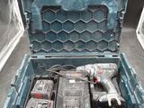 a tool box with a drill and two other tools in it