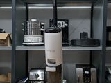 a vacuum that is sitting on a table in front of a shelf