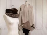 a mannequin in front of a dress and a scarf on a mannequin