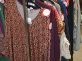 a rack of clothes on display in a clothing store