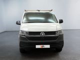 the white van is parked in a room with a black floor