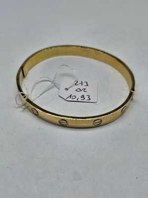 a close up of a gold bracelet with a tag on it