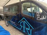 a van that has been painted blue and has a logo on it