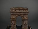 an antique bronze model of the arc of triumph on a marble base