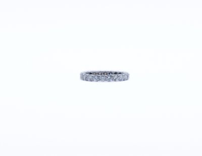 a close up of a diamond ring on a white surface