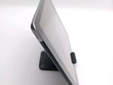 a tablet that is sitting on a stand on a table