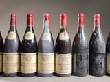 six bottles of wine lined up in a row on a table