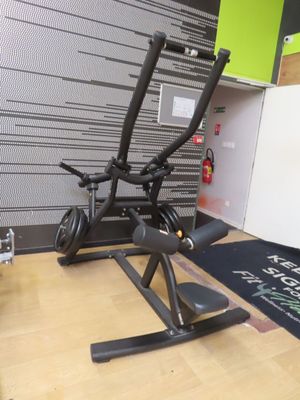 a black exercise bike on a wooden floor in a room