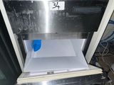 a pink glove sitting on top of an open oven