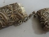pair of antique chinese silver snuffs with dragon heads on them