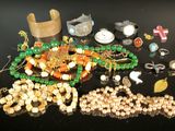 a lot of beads and bracelets on a table