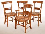 four chairs and a table in a room with a white background
