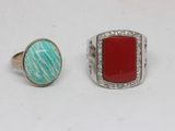 two rings, one with a red stone and one with a turquoise stone