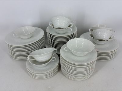 beaucoup d'assiettes et de tasses blanches sur la table