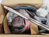 a box that has a vacuum and other items in it