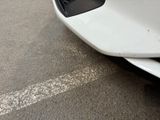 a white car parked on the side of the road