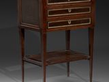 an antique bedside table with three drawers and a shelf on one side