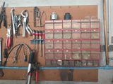 many tools hanging on a pegboard in a garage