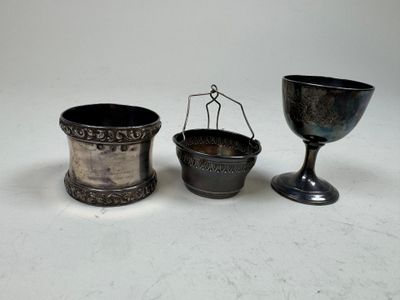 two silver cups and a silver cup on a white surface