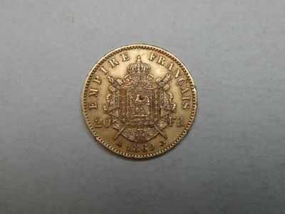 a close up of a gold coin with a coat of arms on it