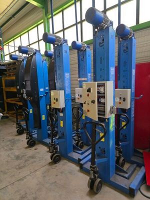 several machines are lined up in a row in a warehouse