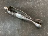 a silver spoon and a spoon rest on the floor